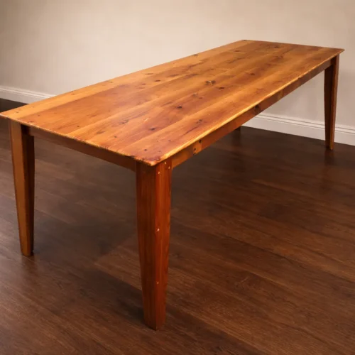 Custom heirloom dining table built from reclaimed heart pine with solid wood construction and visible old-growth grain