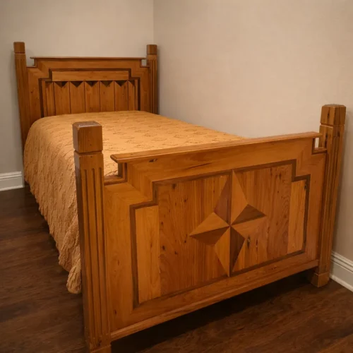 Custom heirloom bed frame built from reclaimed old-growth wood featuring geometric panel design and solid hardwood construction
